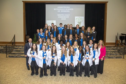 Nursing students standing together and smiling.